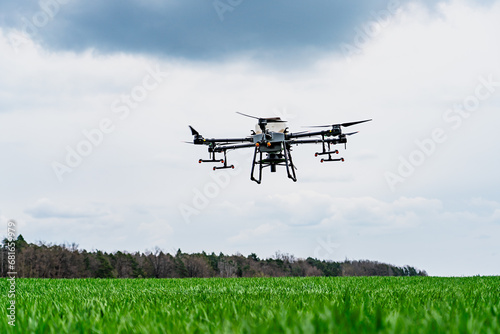 Agriculture drone flying in the sky over a green field