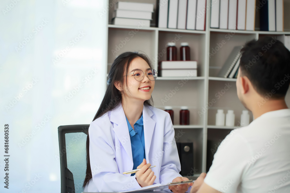 Doctor talking with patient in hospital, The doctor is explaining information about various diseases and treatment methods in detail for the patient to understand before treatment. Doctor talking with patient in hospital, The doctor is explaining information about various diseases and treatment methods in detail for the patient to understand before treatment.