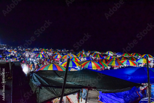Colorful umbrrella of selling shops at the beach market of Puri citya a renound city,beach resort in the beach of Bay of Bengal, Odisa, India, very popular in eastern coast of India. FEBRUARY 2020. photo