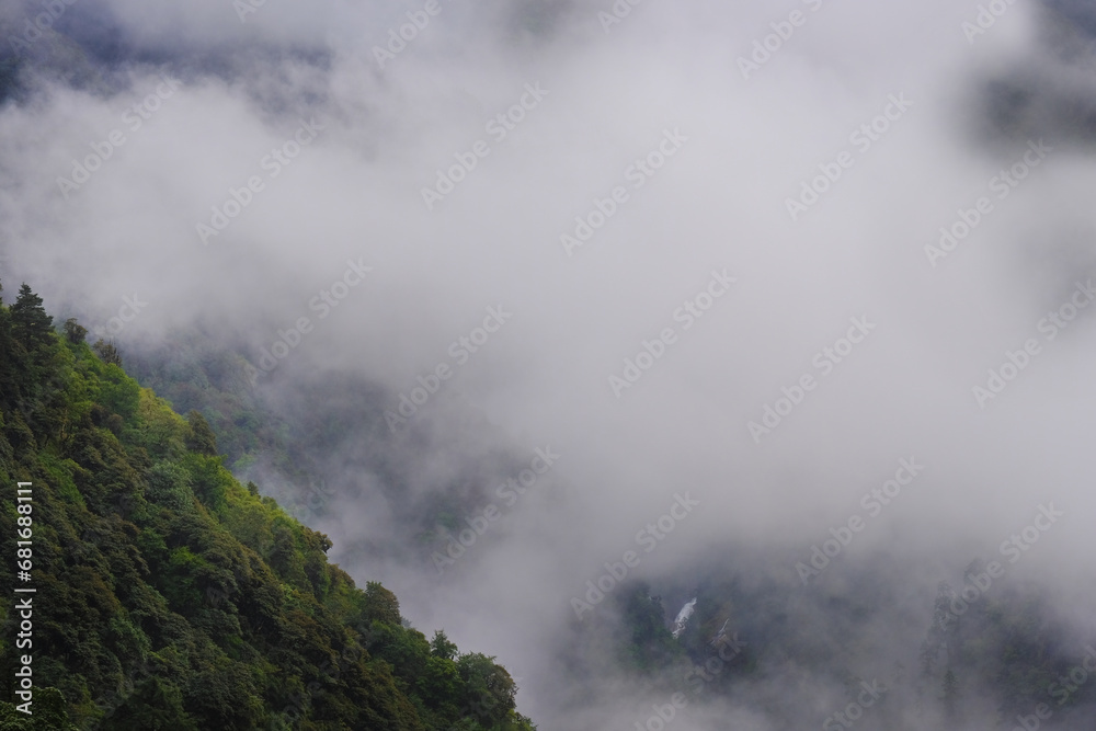 Beautiful misty morning jungles foggy rainforest jungles landscape photo in Makalu Barun National Park near Chatra Khola settlement. Mera peak climbing route, Himalayas, Nepal.