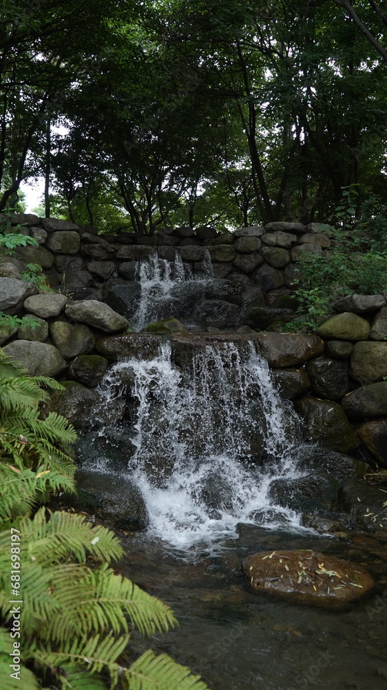 Small artificial waterfall in the park Small artificial waterfall in the park