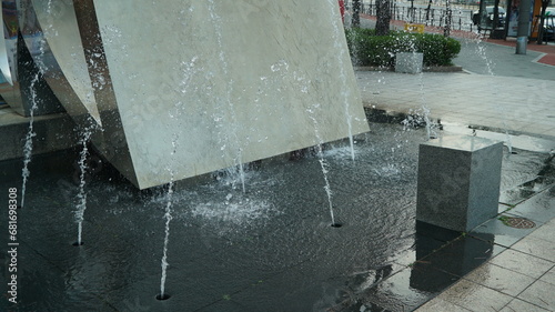 A fountain spouting water from a hole in the ground in a park in Seoul, South Korea photo