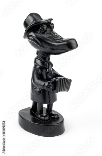 Purchased (consumer) figurine "Crocodile Gene with accordion" made of cast iron close-up on a white background