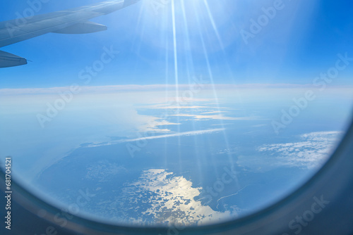 Aerial view of the Astrakhan region, Russia out of focus seen from an airplane with wing in front. Sun rays, glare. photo