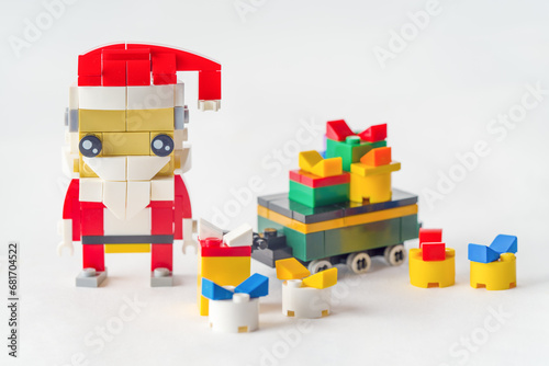 Santa Claus preparing christmas presents Made from Building Blocks. Happy New Year and Merry Christmas. Holidays concept photo