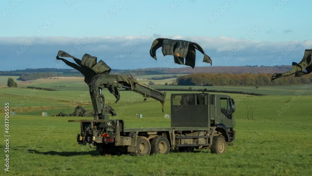 several 1 tonne RAF containerised delivery system (CDS) cargo parachute drops landing and chutes closing several 1 tonne RAF containerised delivery system (CDS) cargo parachute drops landing and chutes closing