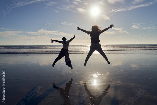 Portrait of Young Indigenous and Tongan Siblings Jumping in the Ocean 