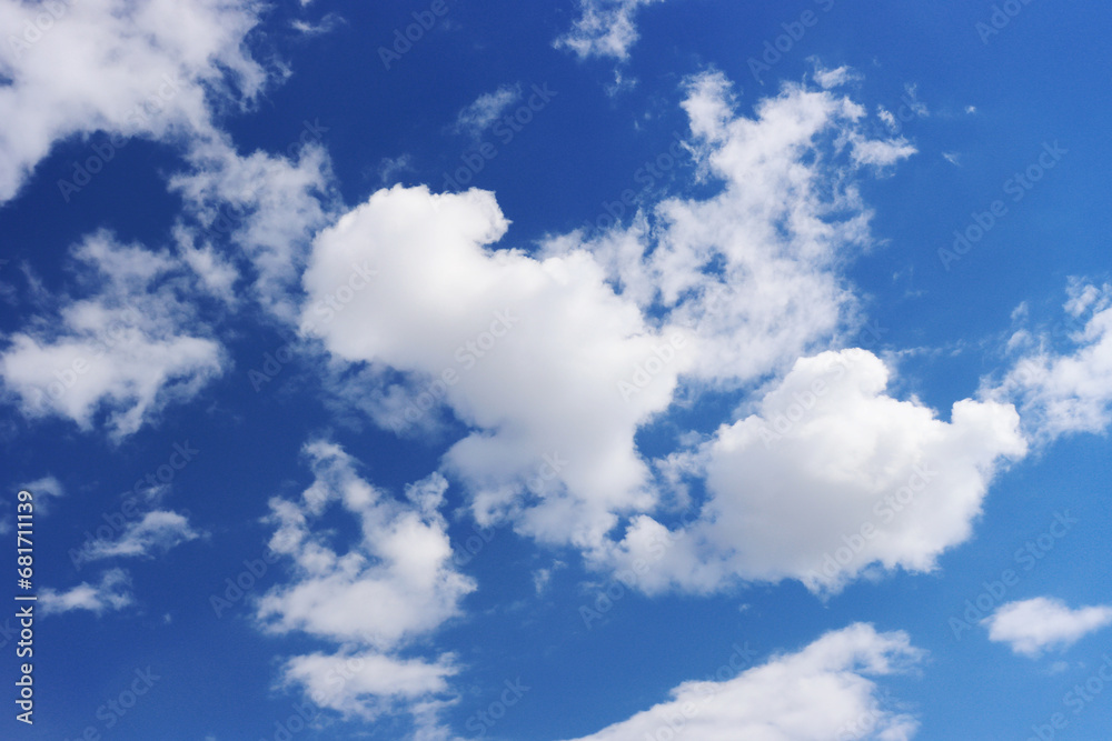 Fototapeta premium Light gray clouds against a blue sky.