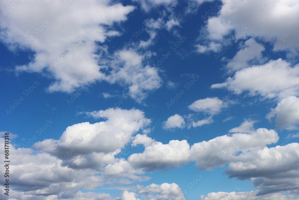 Fototapeta premium Light gray clouds against a blue sky.