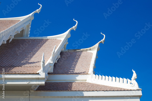 roof with decoration of the Buddhist white temple Wat Sawang Arom against the sky. photo