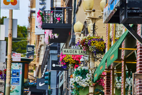 Canvas Print Colorful hanging flowers on Maiden Lane street sign on touristy area of San Fran