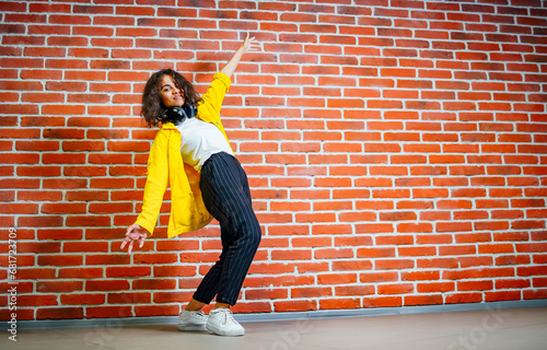 Canvas Print A woman standing in front of a brick wall