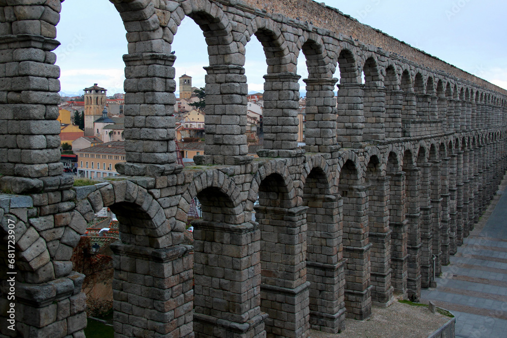 Close-up view of part of the stone arched double-tiered aqueduct in the historic part of the city of Segovia, near Madrid, Spain