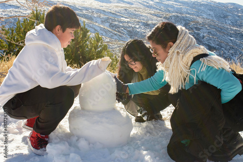 Frosty Delights Latino Family Bonds While Creating Snowman Memories in Sierra Nevada