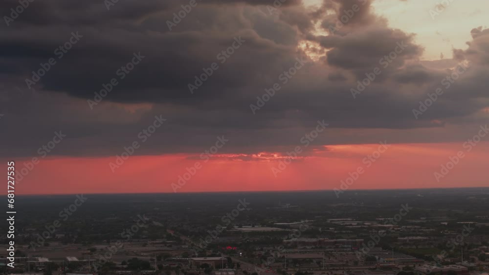 Sunset over housing development. Aerial wide descending shot of houses and homes in city suburb. Sunset over housing development. Aerial wide descending shot of houses and homes in city suburb.