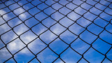 The sky seen through the Chain Link Fence