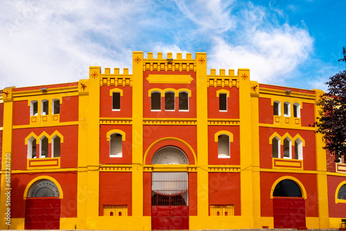 Red and yellow front facade of the Bullring in Mérida, Extremadura in Spain. photo