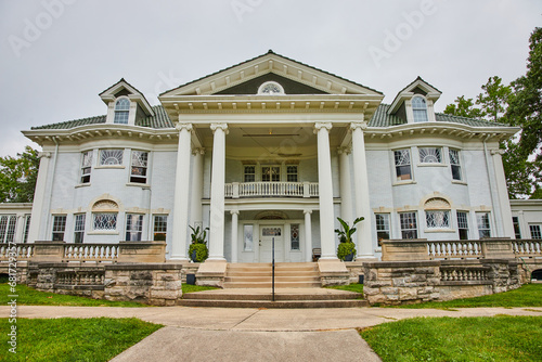 Large white mansion with sidewalk leading to pillars and front door under balcony, Muncie, IN © Nicholas J. Klein