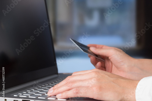 Business woman hands using bank card to pay online