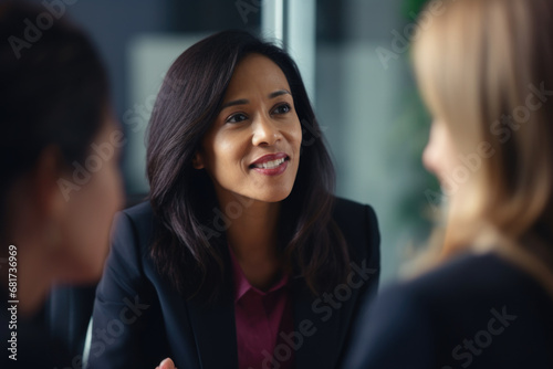 Wallpaper Mural Two women in business suits engaged in conversation. Suitable for business communication and networking concepts Torontodigital.ca