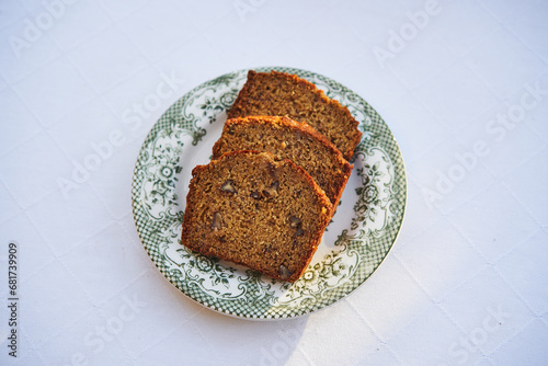 Three slices of freshly baked tasty delicious banana bread on the small vintage porcelain plate isolated. Ideal dish for low carb diet or healthy lifestyle rich in fiber and with balanced nutritions.