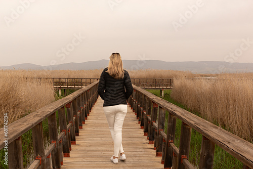 Mujer en puente de madera en las Tablas de Daimiel, Ciudad Real. photo
