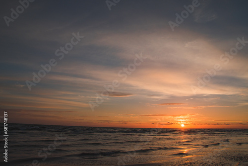 Fototapeta Naklejka Na Ścianę i Meble -  Dramatic sky over tranquil ocean at sunset. Beauty in nature.