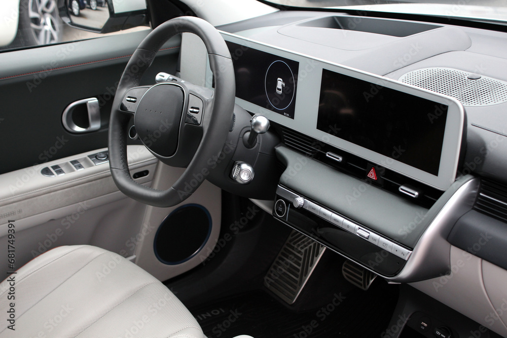 Interior new electric car. Electric car interior details. Electric car dashboard. White leather interior modern electric car. Interior new electric car. Electric car interior details. Electric car dashboard. White leather interior modern electric car.