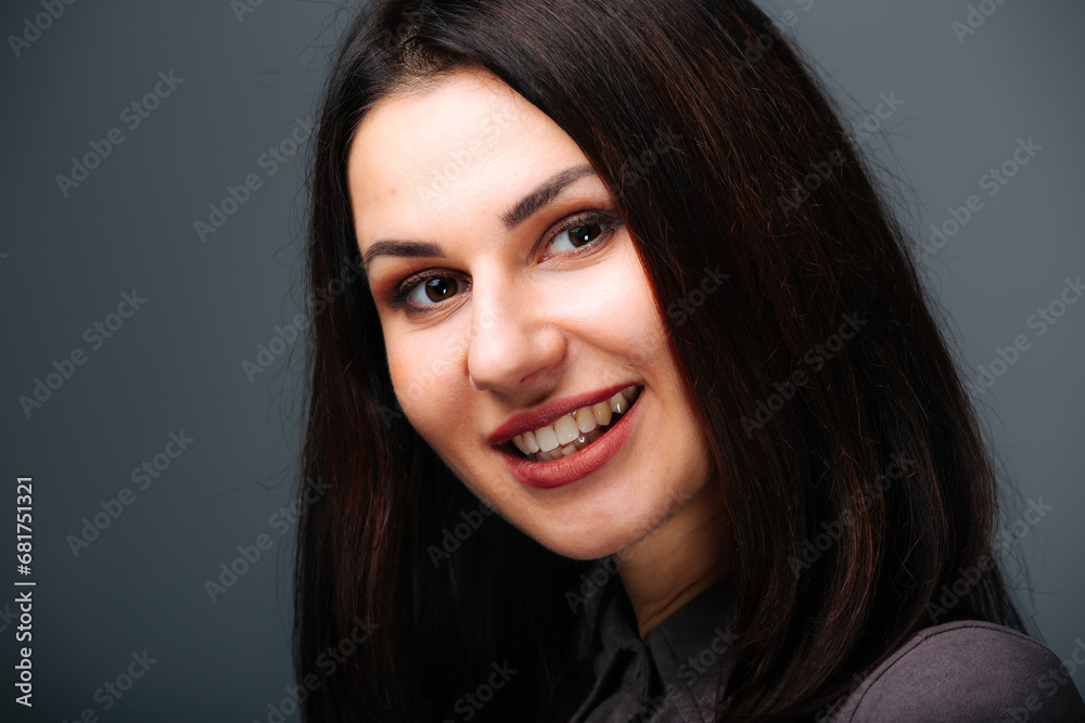 A woman with long dark hair smiling at the camera. The Enchanting Smile of a Woman with Long Dark Hair A woman with long dark hair smiling at the camera. The Enchanting Smile of a Woman with Long Dark Hair