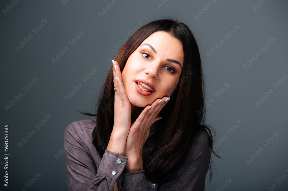 A woman posing for a picture with her hands on her face. A Captivating Portrait of a Woman with Her Hands Gracefully Framing Her Face A woman posing for a picture with her hands on her face. A Captivating Portrait of a Woman with Her Hands Gracefully Framing Her Face