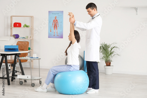 Male doctor checking postur...