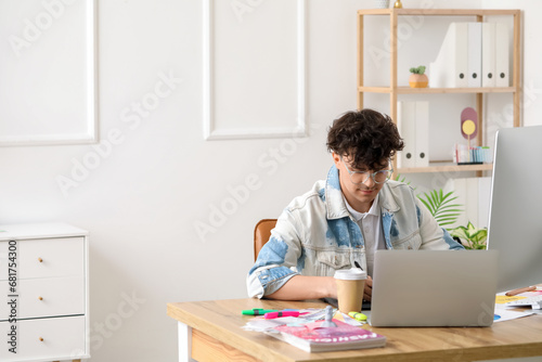 Male graphic designer worki...