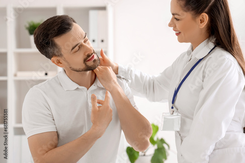 Female physiotherapist working with young man in rehabilitation center