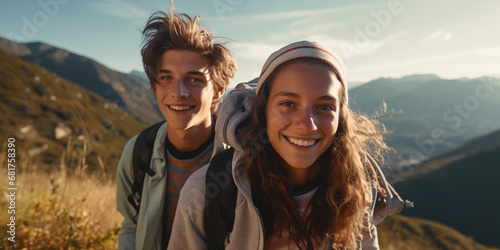 teens boy and girl hiking in the mountains and have fun photo