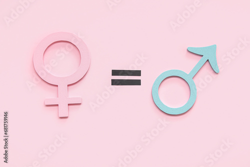 Female and male gender symbols and equal sign on pink background. Gender equality concept photo