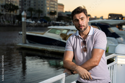 Portrait of handsome confident stylish man in big city. Sexy man in casual clothes posing on the street. Successful male model in the urban lifestyle. Caucasian middle aged man outdoors.