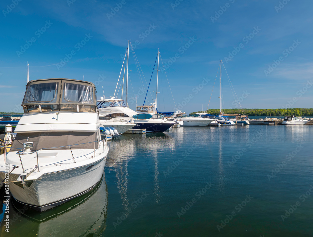 Beautiful morning scene, with motor boats and sailboats moored to the docks in the marina.