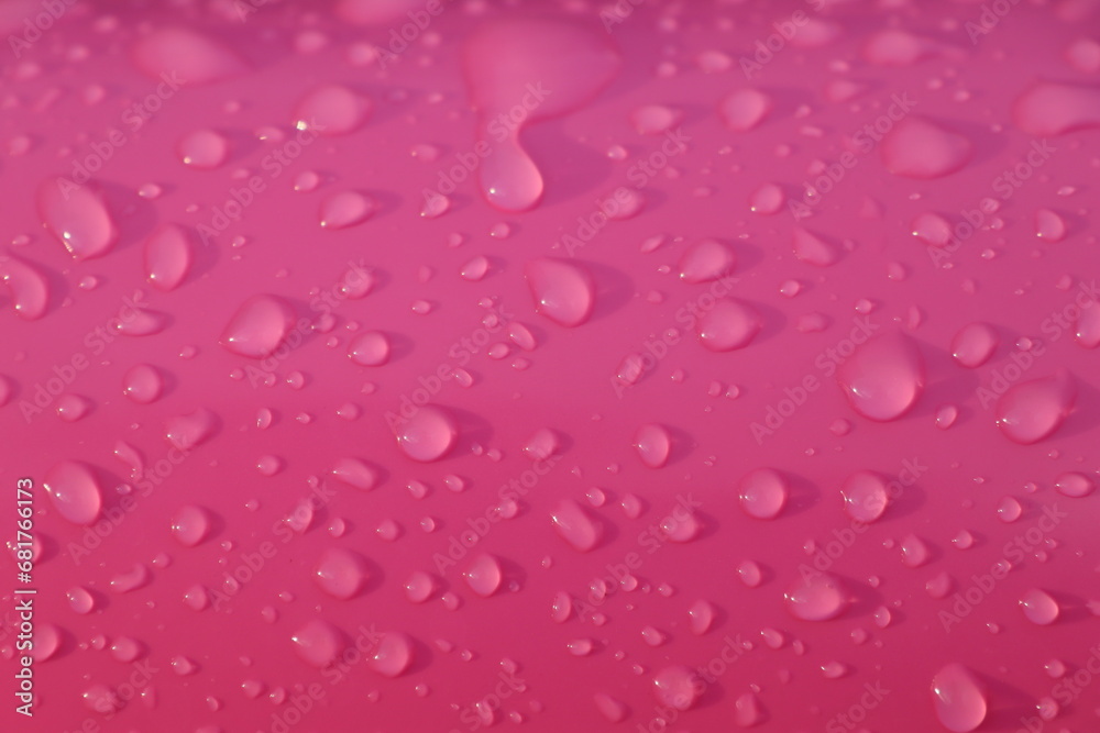 Drops of water after summer rain on pink color children's inflatable ball Drops of water after summer rain on pink color children's inflatable ball