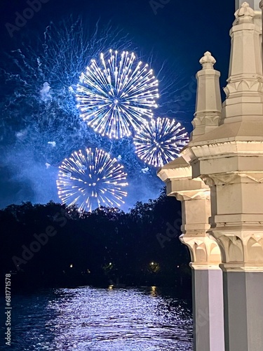 Photography Burns Night, Bonfire Night Blue Firework display over the river Thames with reflection on water and bridge architecture in foreground