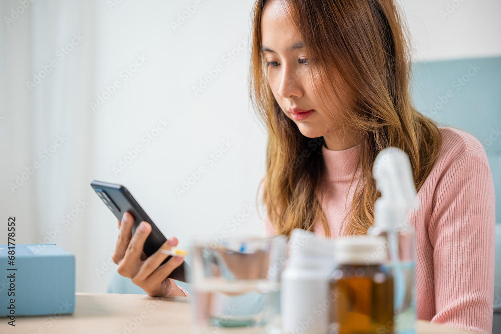 Sick female searching pills information and checking ingredient label and bottle of drug, Asian sick young woman reading medicine prescription on smart mobile phone, smartphone online pharmacy concept Sick female searching pills information and checking ingredient label and bottle of drug, Asian sick young woman reading medicine prescription on smart mobile phone, smartphone online pharmacy concept