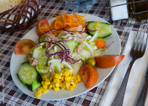 Light salad with fresh cucumbers and tomatoes, Chinese cabbage and canned corn photo