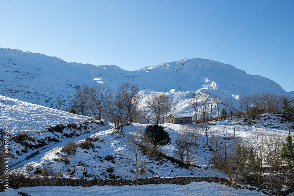 wooden hut in the mountains surrounded by snow