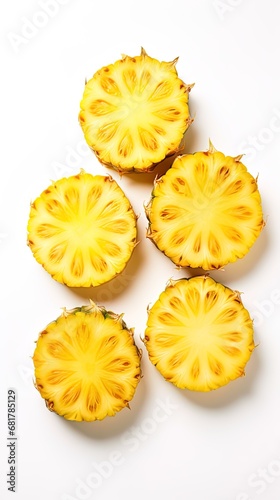 Pineapple slices arranged on a clean white surface for visual appeal