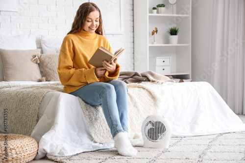 Young woman reading book ne...