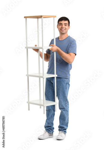 Young man carrying shelf un...