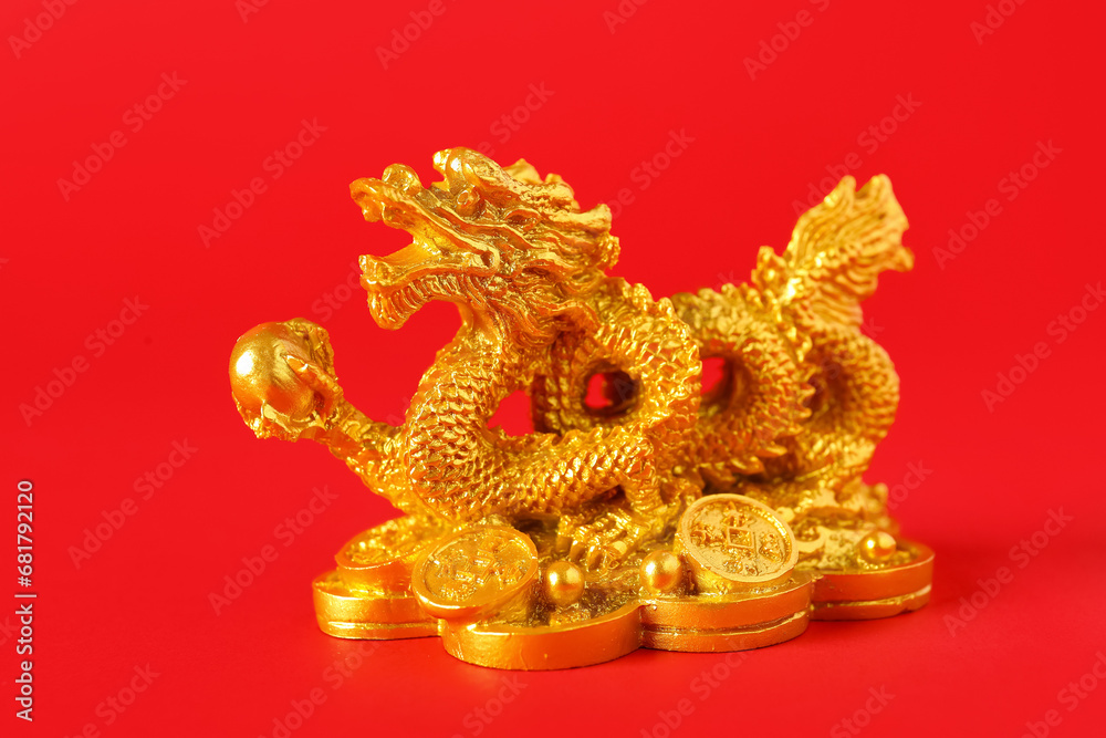 Golden dragon figurine on red background, closeup. Chinese New Year celebration Golden dragon figurine on red background, closeup. Chinese New Year celebration