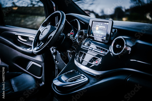 Modern car interior with big multimedia screen, sport steering wheel
