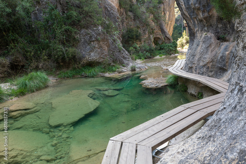 Wooden path over Matarrana river at The Parrizal spot in Beceite, Teruel, Spain