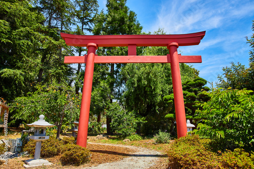 Red Torii Gate in Japanese Garden with stone lanterns lining path at The Gardens at Lake Merritt