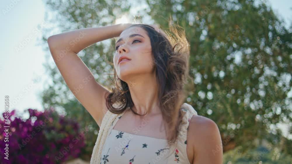 Woman posing trees greenery background portrait. Sexy girl touching windy hair Woman posing trees greenery background portrait. Sexy girl touching windy hair